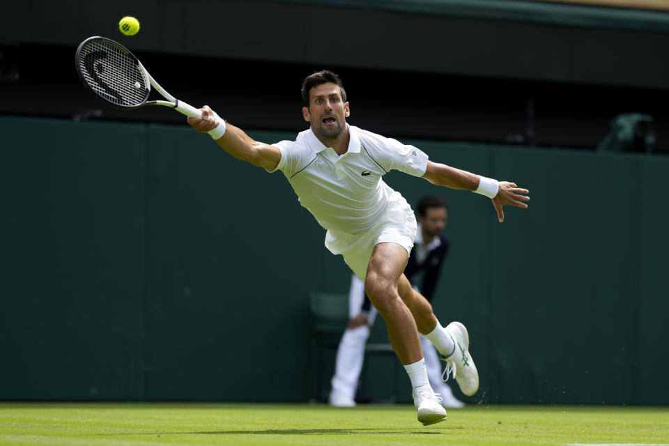 Serbia's Novak Djokovic returns the ball to Australia's Thanasi Kokkinakis during their singles tennis match on day three of the Wimbledon tennis championships in London, Wednesday, June 29, 2022. (AP Photo/Alastair Grant)