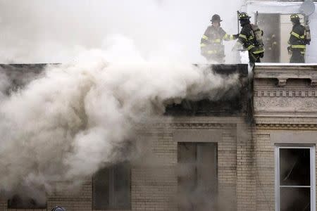 Firefighters respond to an apparent gas explosion and fire in the Brooklyn borough of New York, October 3, 2015. REUTERS/Stephanie Keith