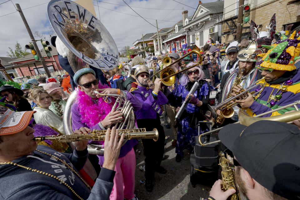 The Krewe du Belge plays during the Society of Saint Anne parade through Bywater and Marigny neighborhoods on Mardi Gras Day in New Orleans, Tuesday, Feb. 13, 2024. (AP Photo/Matthew Hinton)