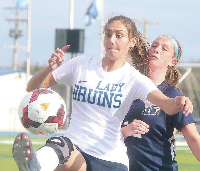 Bartlesville High School’s Briley-Anne Brown wages a fierce battle for positioning during Lady Bruin soccer action from 2018. Mike Tupa/Examiner-Enterprise