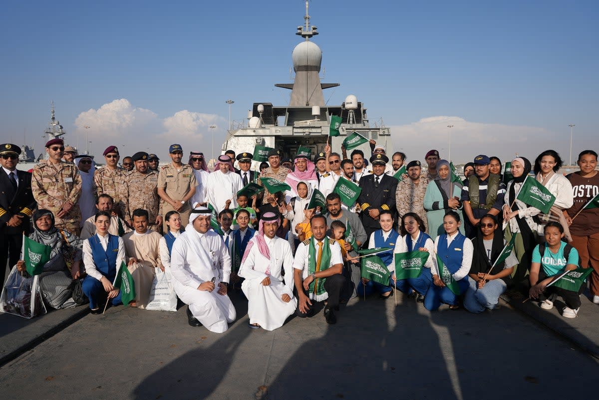 Saudi citizens and staff of Saudi Airline pose for a group photo as they arrive at Jeddah Sea Port (via REUTERS)
