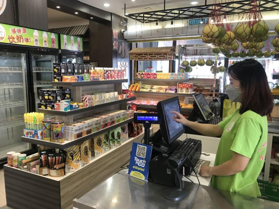 Kedai Biskut Minisu Store worker Chloe says visitors to its store have increased significantly. — Picture by Farhan Najib