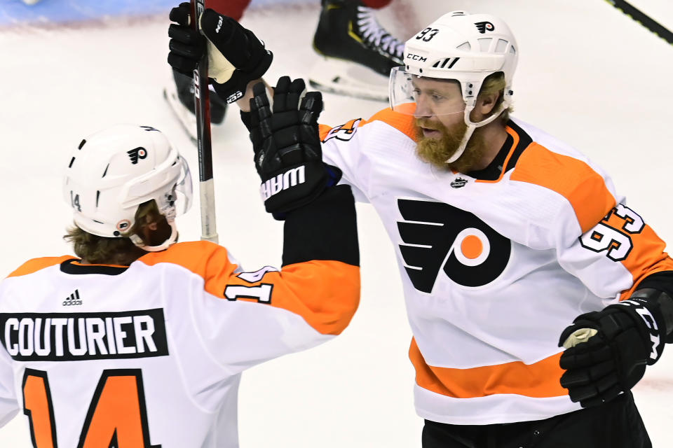 Philadelphia Flyers right wing Jakub Voracek (93) celebrates his goal against the Montreal Canadiens with Sean Couturier (14) during the first period of Game 3 of an NHL hockey playoff first-round series Sunday, Aug. 16, 2020, in Toronto. (Frank Gunn/The Canadian Press via AP)