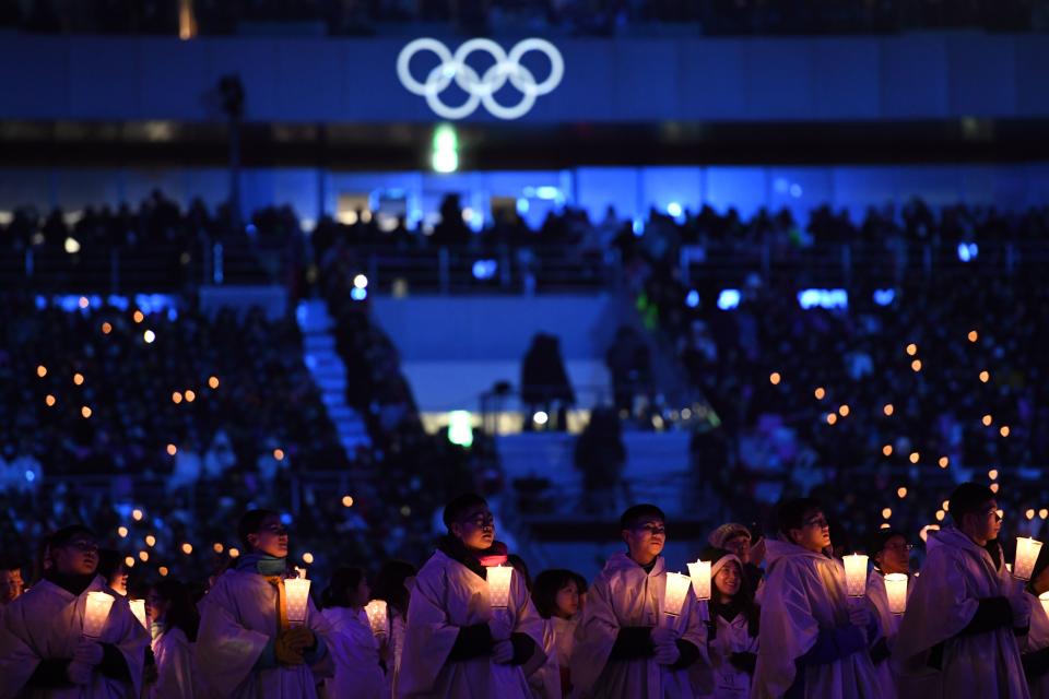 <p>Actors hold candles during the opening ceremony of the Pyeongchang 2018 Winter Olympic Games at the Pyeongchang Stadium on February 9, 2018. / AFP PHOTO / Kirill KUDRYAVTSEV </p>