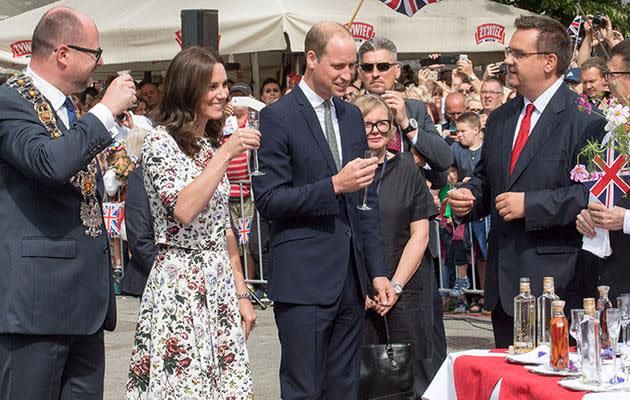 The royals were seen taking a shot during a visit to a market place. Photo: Getty