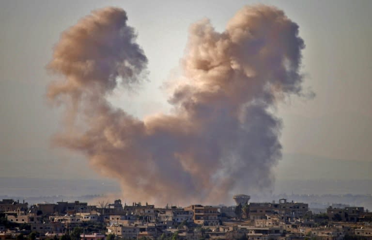 Smoke rises above a rebel-held area of southern Syria during a government air strike on Daraa province on June 27, 2018