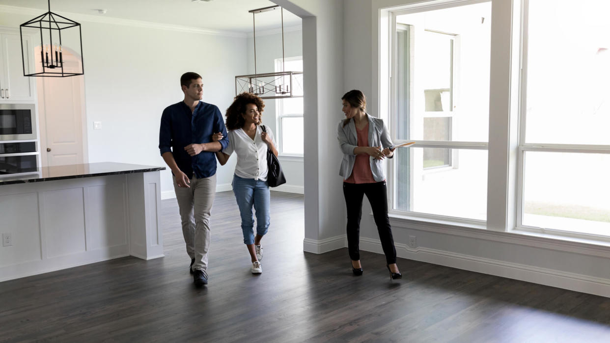 Realtor shows a couple a home.