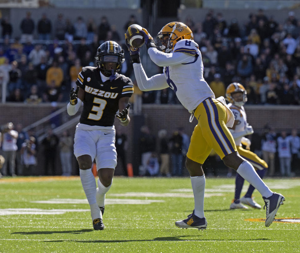 LSU safety Major Burns (8) intercepts a pass intended for Missouri wide receiver Luther Burden III (3) before running it back to score in the second half of an NCAA college football game Saturday, Oct. 7, 2023, in Columbia, Mo. (Hilary Scheinuk/The Advocate via AP)