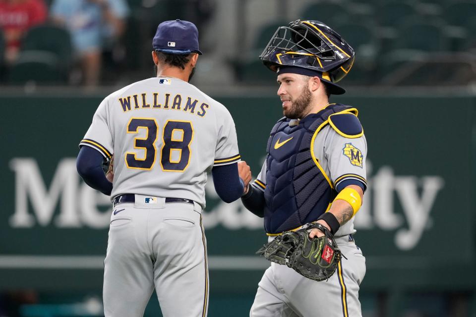 Closer Devin Williams and catcher Victor Caratini greet each other after the Brewers beat the Rangers on Sunday to complete a three-game sweep of the series.