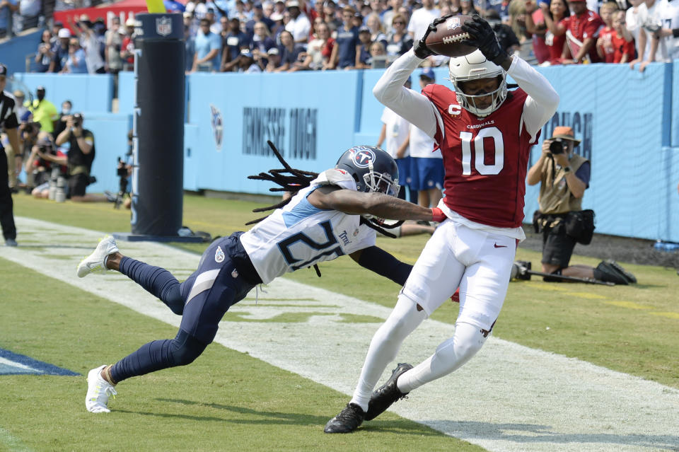 Arizona Cardinals wide receiver DeAndre Hopkins (10) catches a touchdown pass as he is defended by Tennessee Titans cornerback Jackrabbit Jenkins (20) in the first half of an NFL football game Sunday, Sept. 12, 2021, in Nashville, Tenn. (AP Photo/Mark Zaleski)