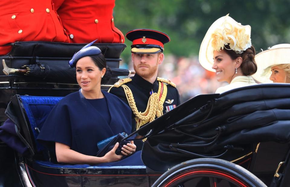 The Duke and Duchess of Sussex with the Duchess of Cambridge make their way along The Mall to Horse Guards Parade ahead of the Trooping the Colour ceremony in 2019 (PA) (PA Archive)