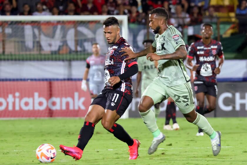 Alajuelense Sports League's (LDA) Alexander Lopez (L) goes for the ball against Los Angeles Futbol Club's (LAFC) Kellyn Acosta (R) during the Champions League match of the Concacaf 2023 at the Alejandro Morera Soto stadium in Alajuela, Costa Rica, March 9, 2023. (Photo by Randall CAMPOS/AFP) (Photo by RANDALL CAMPOS/AFP via Getty Images)