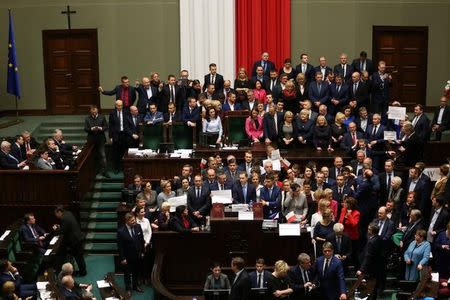 Polish opposition parliamentarians protest against the rules proposed by the head office of the Sejm, the lower house of parliament, that would ban all recording of parliamentary sessions except by five selected television stations and limits the number of journalists allowed in the building, in the Parliament in Warsaw, Poland December 16, 2016. Slawomir Kaminski/Agencja Gazeta/via REUTERS