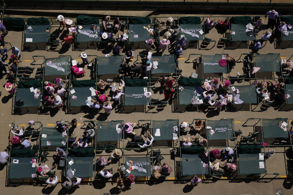 Fans wait for a race while social distancing before 147th running of the Kentucky Oaks at Churchill Downs, Friday, April 30, 2021, in Louisville, Ky. (AP Photo/Charlie Riedel)