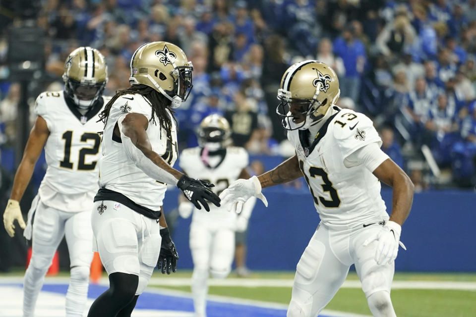 New Orleans Saints running back Alvin Kamara, left, celebrates his 18-yard touchdown reception with Michael Thomas (13) against the Indianapolis Colts during the first half of an NFL football game Sunday, Oct. 29, 2023 in Indianapolis. (AP Photo/Michael Conroy)