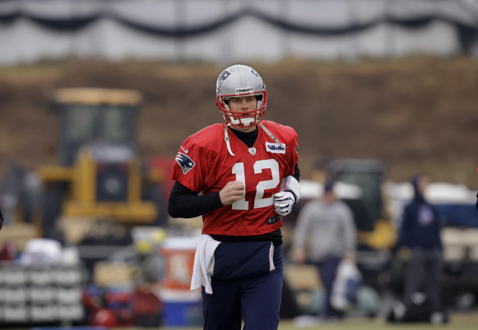 New England Patriots quarterback Tom Brady (12) runs during a drills and stretching session before practice begins at the NFL football team's facility in Foxborough, Mass., Thursday, Jan. 16, 2014. The Patriots will play the Denver Broncos in the AFC Championship game Sunday in Denver. (AP Photo/Stephan Savoia)