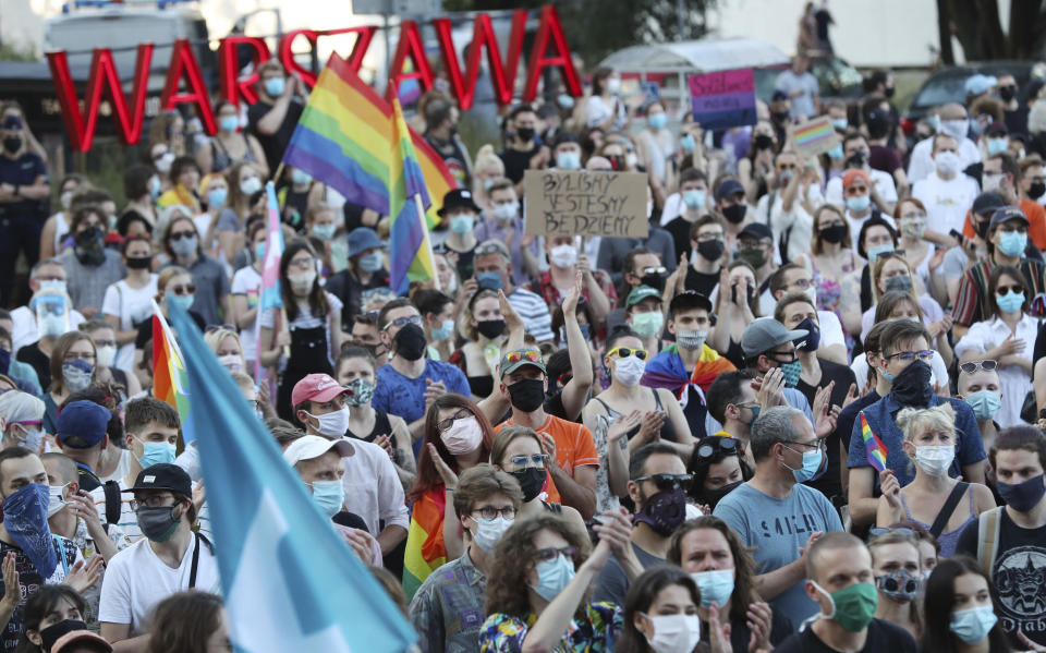 LGBT rights supporters protest in Warsaw, Poland, Saturday, Aug. 8, 2020. A large crowd of LGBT rights supporters gathered in Warsaw on Saturday to protest the arrest of a transgender activist who had carried out acts of civil disobedience against rising homophobia in Poland. (AP Photo/Czarek Sokolowski)