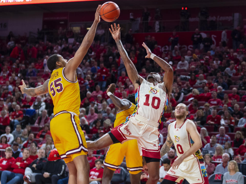 Minnesota's Ta'Lon Cooper attempts to block a shot by Nebraska's Jamarques Lawrence during the second half of an NCAA college basketball game, Saturday, Feb. 25, 2023, at Pinnacle Bank Arena in Lincoln, Neb. (Kenneth Ferriera/Lincoln Journal Star via AP)