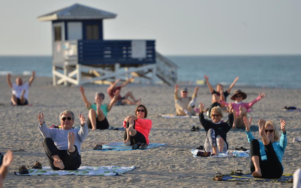 Visitors do Yoga on Venice Beach.