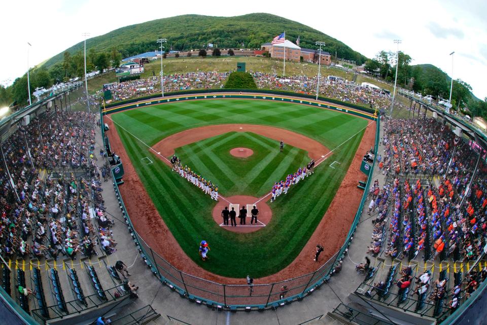 The Little League team from Davenport, Iowa, lines the first baseline and Hagerstown, Ind. lines the third baseline during player introductions before a baseball game in Lamade Stadium at the Little League World Series in South Williamsport, Pa., Thursday, Aug. 18, 2022.
