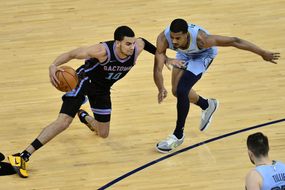 Sacramento Kings guard Justin James (10) handles the ball against Memphis Grizzlies guard De'Anthony Melton (0) in the second half of an NBA basketball game Friday, May 14, 2021, in Memphis, Tenn. (AP Photo/Brandon Dill)