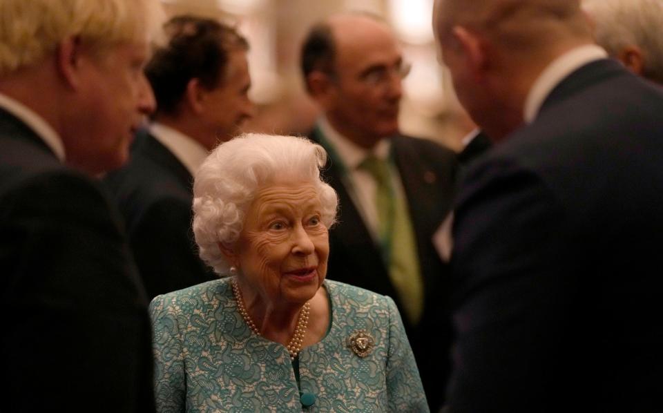 The Queen greets guests at a reception for the Global Investment Summit in Windsor Castle - Alastair Grant/AP