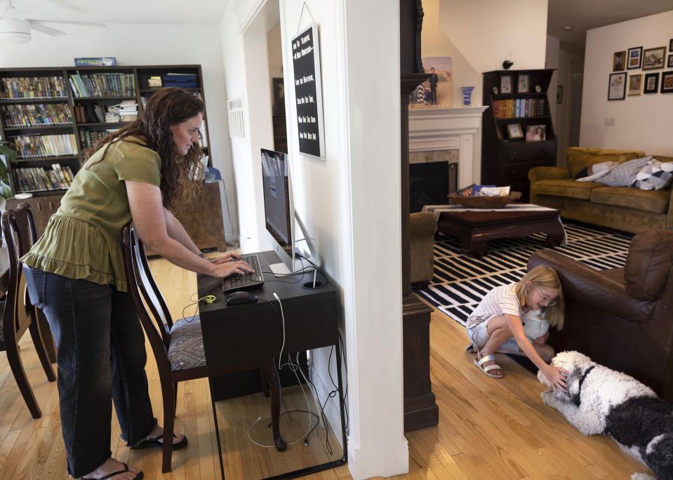 Karyn Tripp logs onto the CTCMath program as her daughter, Millie, 9, plays with the family dog at their home in Cedar Hills on Wednesday, Aug. 30, 2023. | Laura Seitz, Deseret News