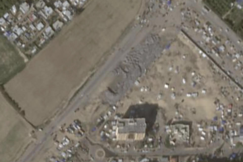 This Jan 21, 2024, image provided by Planet Labs PBC shows an informal landfill, center, in the city of Khan Younis that sprung up after Oct. 7. Since the Rafah evacuation, a tent city has sprung up around the landfill, with Palestinians living in between piles of garbage. (Planet Labs PBC via AP)