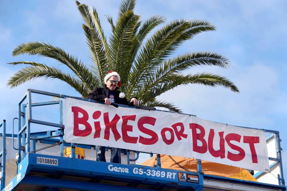 Highway 98 Country radio host Bo Reynolds checks out the view from atop a construction lift at the start of the station's annual "Bikes or Bust" event at Uptown Station. Reynolds will spend 98 hours living atop the lift in order encourage listeners to donate bicycles to Emerald Coast Toys for Tots.