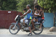 A family rides together on a motorbike in Aracataca, the hometown of the late Nobel laureate Gabriel Garcia Marquez along Colombia's Caribbean coast on Friday, April 18, 2014. Garcia Marquez died on Thursday in Mexico City. Although the author evoked his homeland's beauty in his novels and visited frequently, he never again resided there permanently, instead spending his time in Europe and Mexico City, where his cremated remains will be displayed at a memorial service Monday. (AP Photo/Ricardo Mazalan)