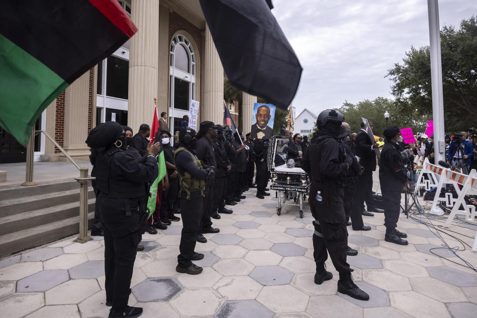 Dozens of Black Lives Matter and Black Panther protesters gather outside the Glynn County Courthouse where the trial of Travis McMichael, his father, Gregory McMichael, and William "Roddie" Bryan is held, Monday, Nov. 22, 2021, in Brunswick, Ga. The three men charged with the February 2020 slaying of 25-year-old Ahmaud Arbery. (AP Photo/Stephen B. Morton)