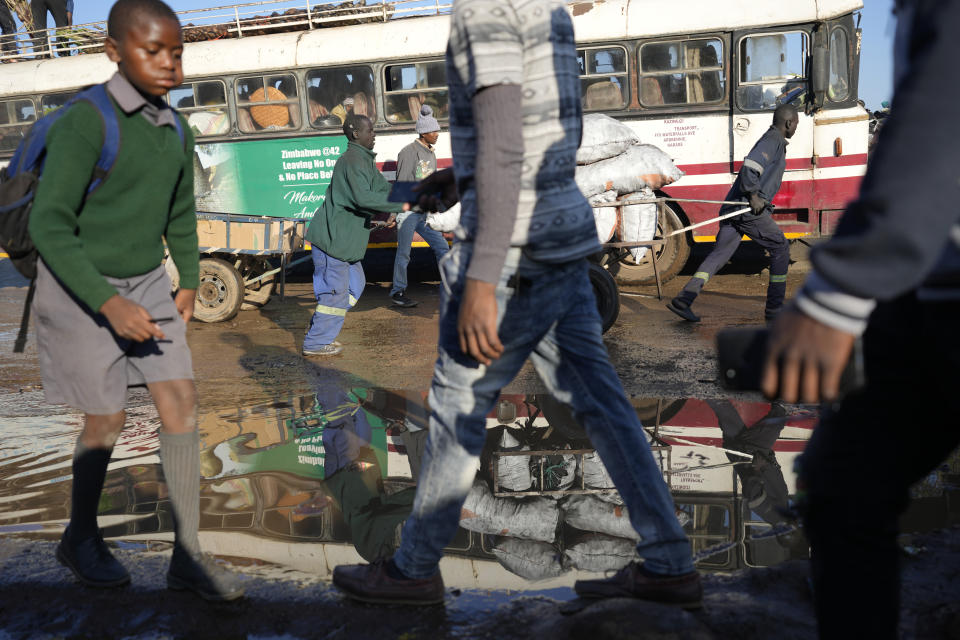 People are seen going about their business at a market in Harare, Tuesday May, 31, 2022. Rampant inflation is making it increasingly difficult for people in Zimbabwe to make ends meet. Since the start of Russia’s war in Ukraine, official statistics show that Zimbabwe’s inflation rate has shot up from 66% to more than 130%. The country's finance minister says the impact of the Ukraine war is heaping problems on the already fragile economy. (AP Photo/Tsvangirayi Mukwazhi)