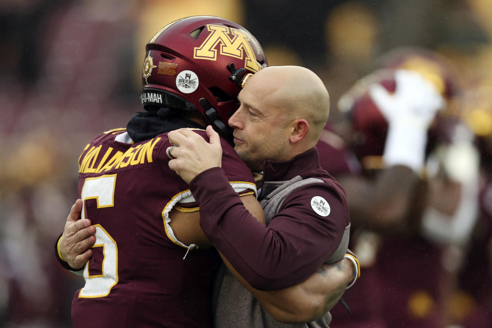 FILE - In this Saturday, Nov. 30, 2019, file photo, Minnesota head coach P.J. Fleck hugs defensive back Chris Williamson (6) during an NCAA college football game against Wisconsin, in Minneapolis. Fleck has never lacked for clever ways to connect and motivate his players. (AP Photo/Stacy Bengs, File)
