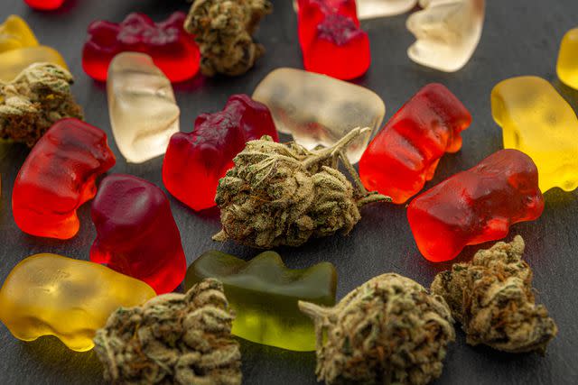 <p>Getty</p> A photograph of gummy bears and marijuana