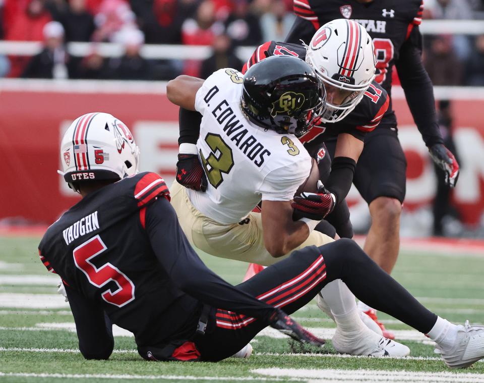 Utah Utes cornerback Zemaiah Vaughn (5) and Utah Utes cornerback Smith Snowden (17) tackle Colorado Buffaloes running back Dylan Edwards (3) in Salt Lake City on Saturday, Nov. 25, 2023. Utah won 23-17. | Jeffrey D. Allred, Deseret News