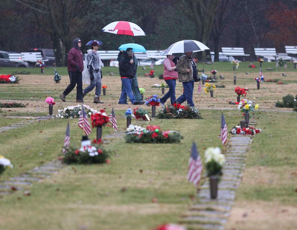 Volunteers arrive as a couple thousand people brave rainy weather to decorate graves at the Delaware Veterans Memorial Cemetery in Bear as part of Wreaths Across America, back in 2018. The effort was duplicated at the state veterans memorial cemetery in Millsboro and throughout the nation at more than 1400 locations that Saturday.