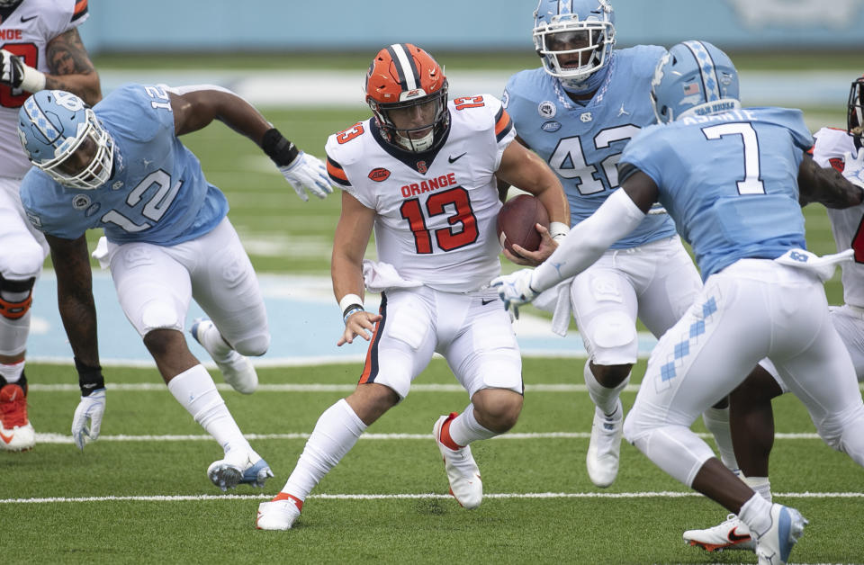 Syracuse quarterback Tommy DeVito (13) looks for running room against North Carolina's Eugene Asanti (7) during the second quarter of an NCAA college football game Saturday, Sept. 12, 2020 in Chapel Hill, N.C. (Robert Willett/The News & Observer via AP, Pool)