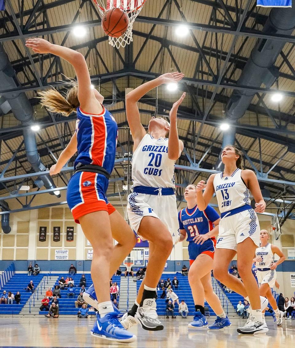 Franklin Community Grizzley Cubs Emma Sappenfield (20) attempts to guard Whiteland's guard Addison Emberton (15) on Thursday, Nov. 16, 2023, during the semifinals of the Johnson County Tournament at Franklin Community High School in Franklin. The Franklin Community Grizzley Cubs defeated the Whiteland, 68-30.