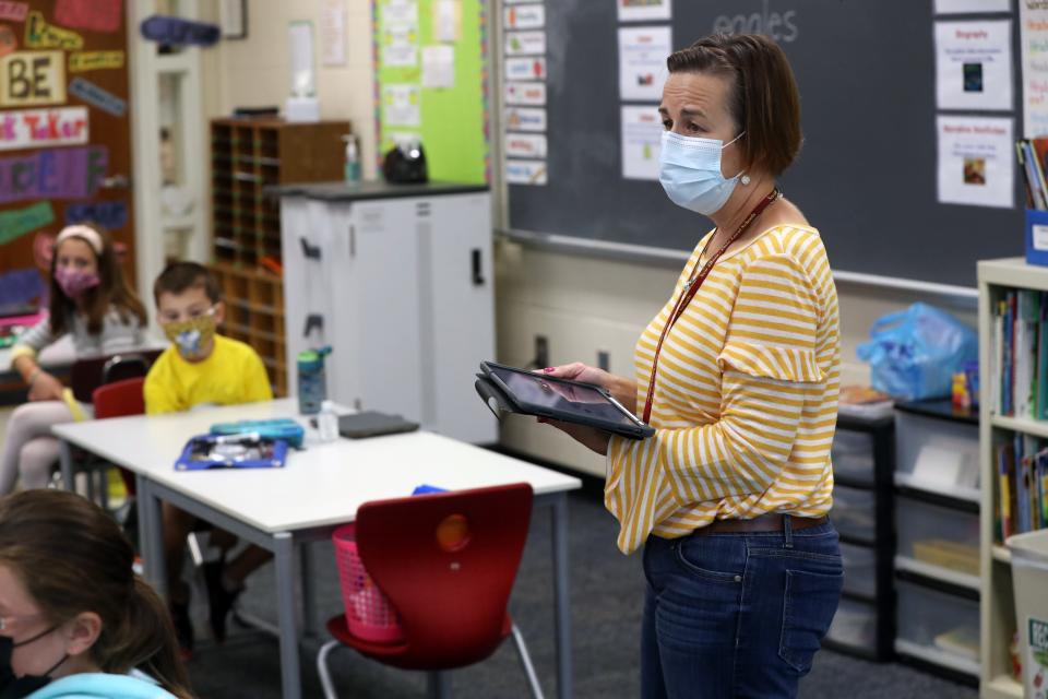 Second-grade teacher Jennifer Thompson goes through a lesson with her students Sept. 15 at New Albany Primary School. The New Albany-Plain Local Schools Board of Education decided face masks worn by students and staff in prekindergarten through sixth grade will be optional upon return from winter break Jan. 4.