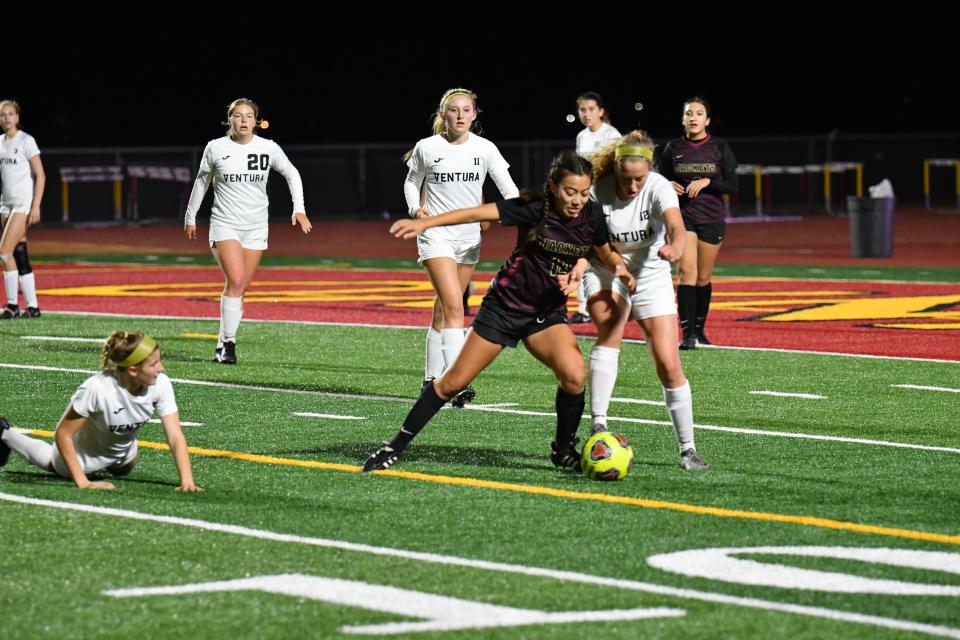 Oxnard senior Malia Tarazon is tackled by Ventura freshman Olivia Mobley during the host Yellowjackets' 3-2 win over the Cougars on Jan. 13.