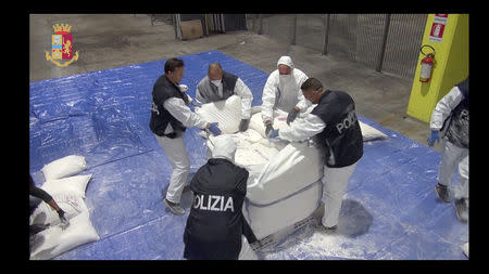 Police officers check bags found in Genoa harbour in this video grab provided by the Italian Police, November 8, 2018. Polizia Di Stato/Handout via REUTERS