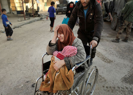 A displaced Iraqi woman cries while fleeing her home, as Iraqi forces battle with Islamic State militants, in western Mosul, Iraq March 8, 2017. REUTERS/Zohra Bensemra