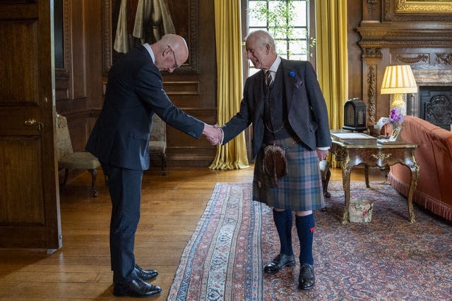 Scottish First Minister John Swinney bows to the King on Wednesday