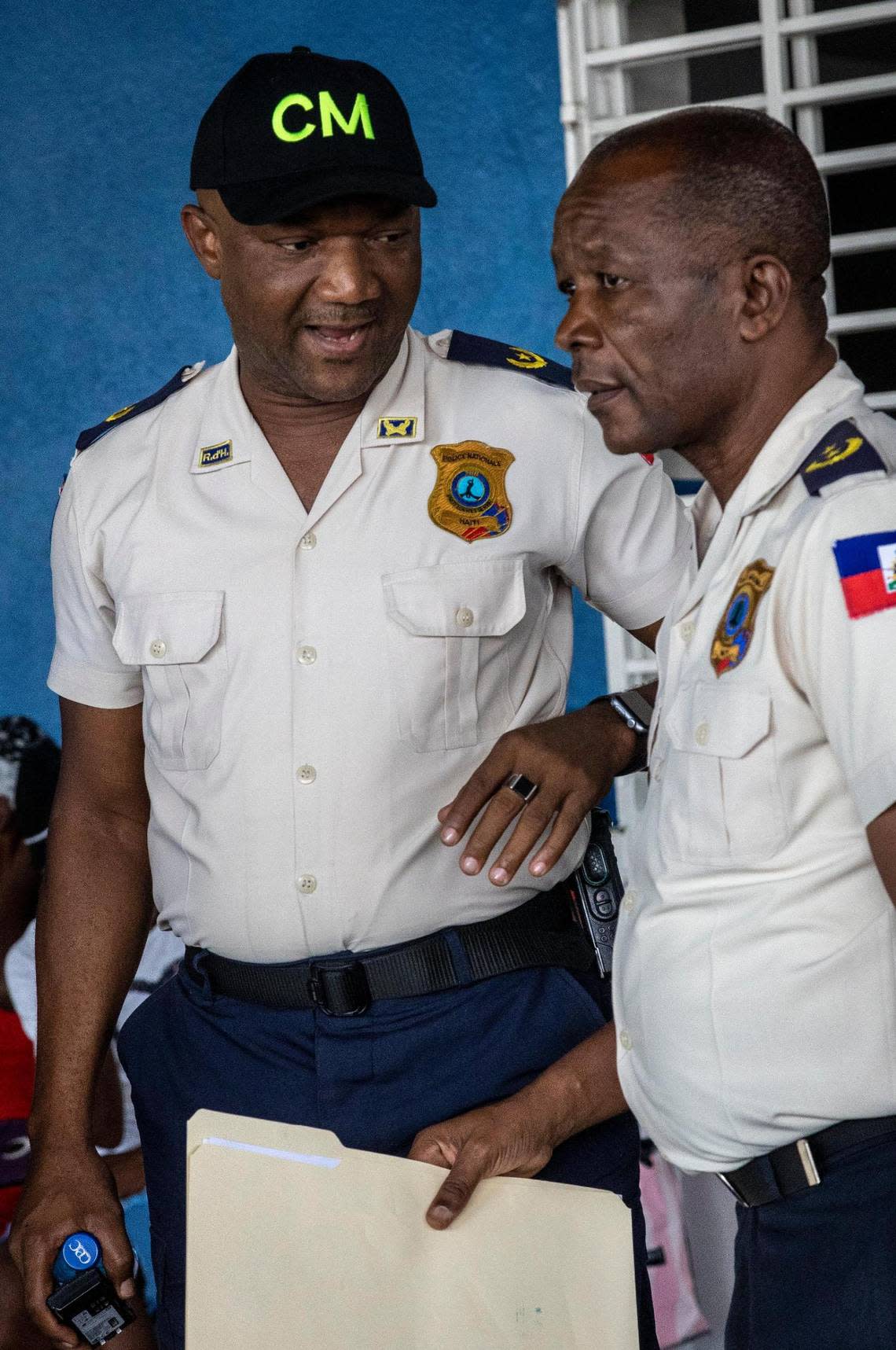 Haiti National Police Commissioner Livenston Gauthier, left, who is in charge of the Tabarre District, speaks to Principal Commissioner of Police Roger Lamartinière, who is responsible for Croix-des-Bouquets. Both have been working together to stave off control of the region by gangs.