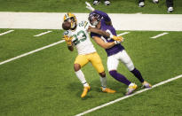 Green Bay Packers defender Jaire Alexander, left, intercepts a pass intended for Minnesota Vikings wide receiver Adam Thielen, right, in the second quarter of an NFL football game Sunday, Sept. 13, 2020, in Minneapolis. (Jerry Holt/Star Tribune via AP)