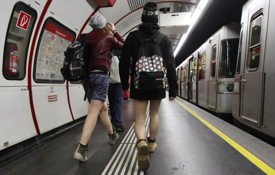 Passengers without their pants walk on a underground platform during the "No Pants Subway Ride" in Vienna