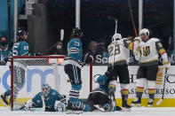 Vegas Golden Knights right wing Keegan Kolesar, right, is congratulated by left wing William Carrier (28) after scoring against San Jose Sharks goaltender Alexei Melnichuk, bottom left, during the first period of an NHL hockey game in San Jose, Calif., Wednesday, May 12, 2021. (AP Photo/Jeff Chiu)