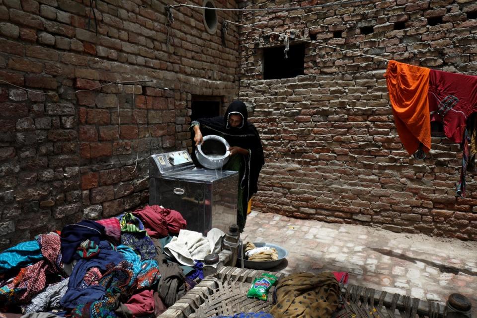 Zahida, 16, washes clothes during a heatwave (Reuters)