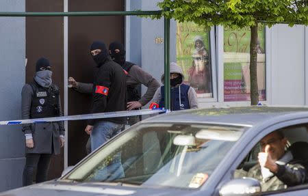 Belgium special forces police secure access during a police operation to search an apartment complex in the Brussels district of Uccle, Belgium, April 12, 2016. REUTERS/Yves Herman