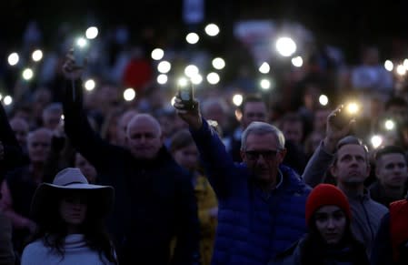 Demonstrators light up their mobile phones as they attend an anti-government protest rally in reaction to last year's killing of the investigative reporter Jan Kuciak and his fiancee Martina Kusnirova in Bratislava